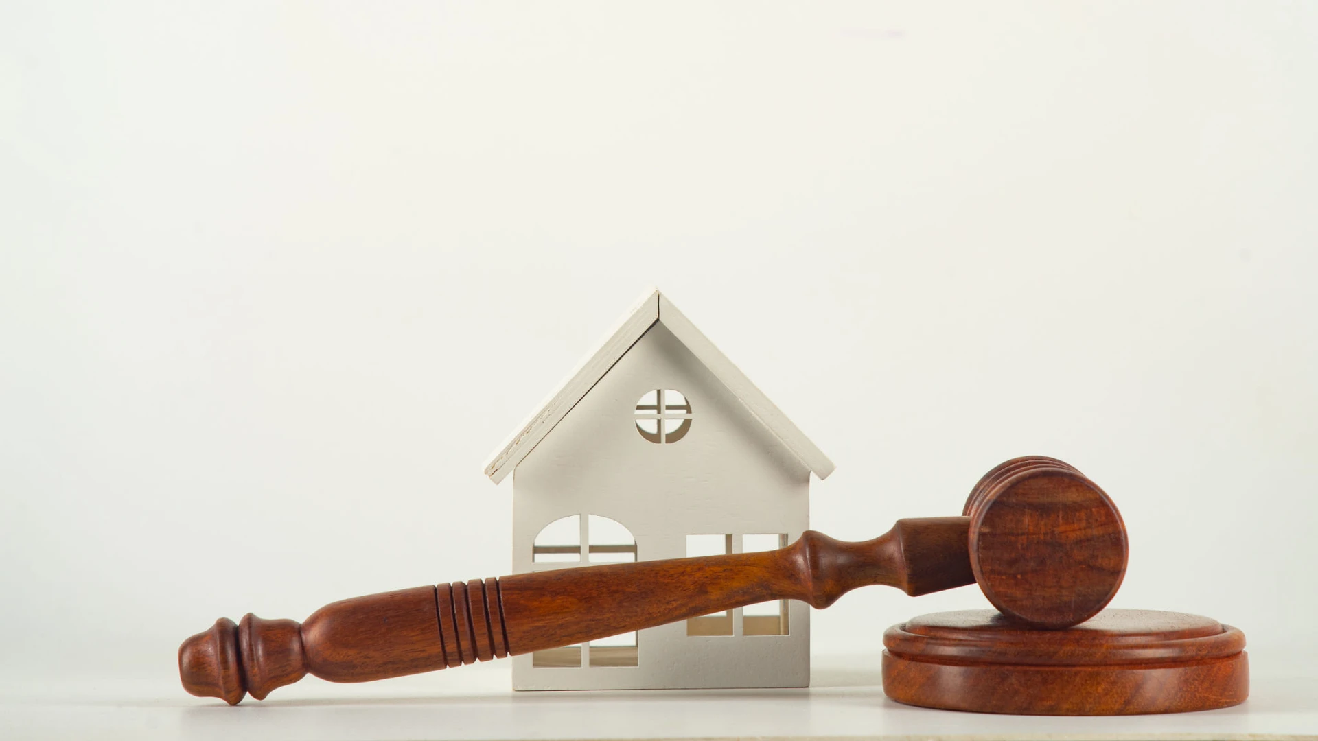 gavel and block with toy house